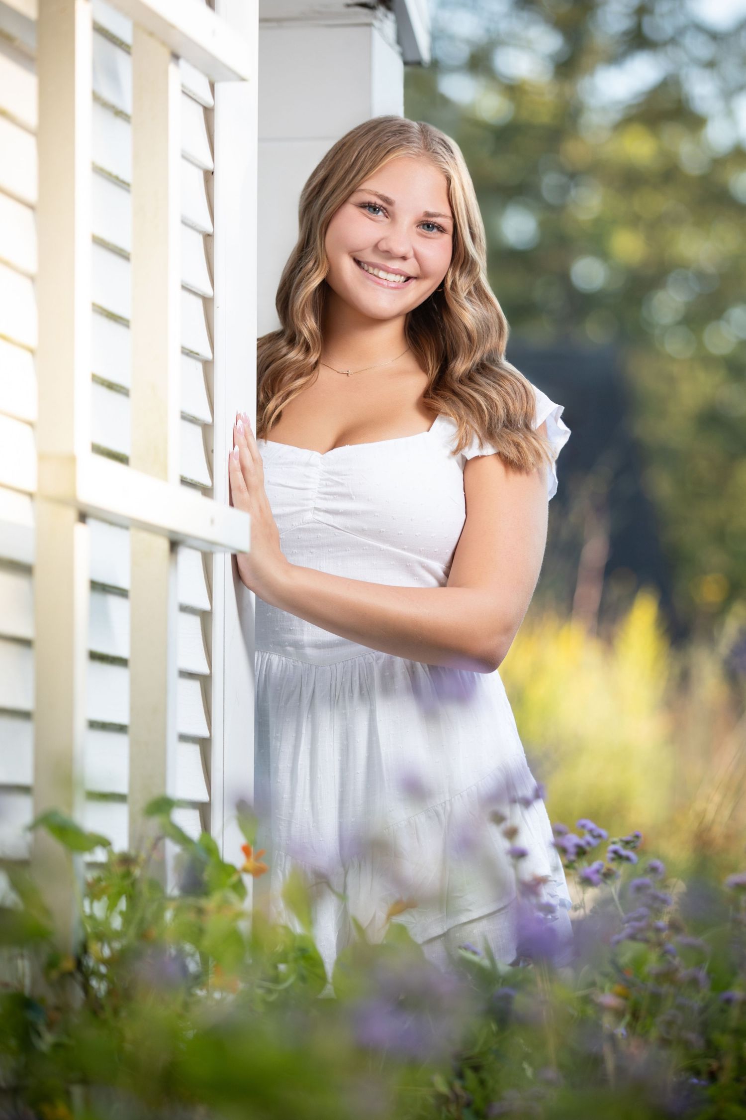 Olentangy senior portrait session at Inniswood Metro Gardens with a white dress, flowers, and dreamy outdoor scenery.