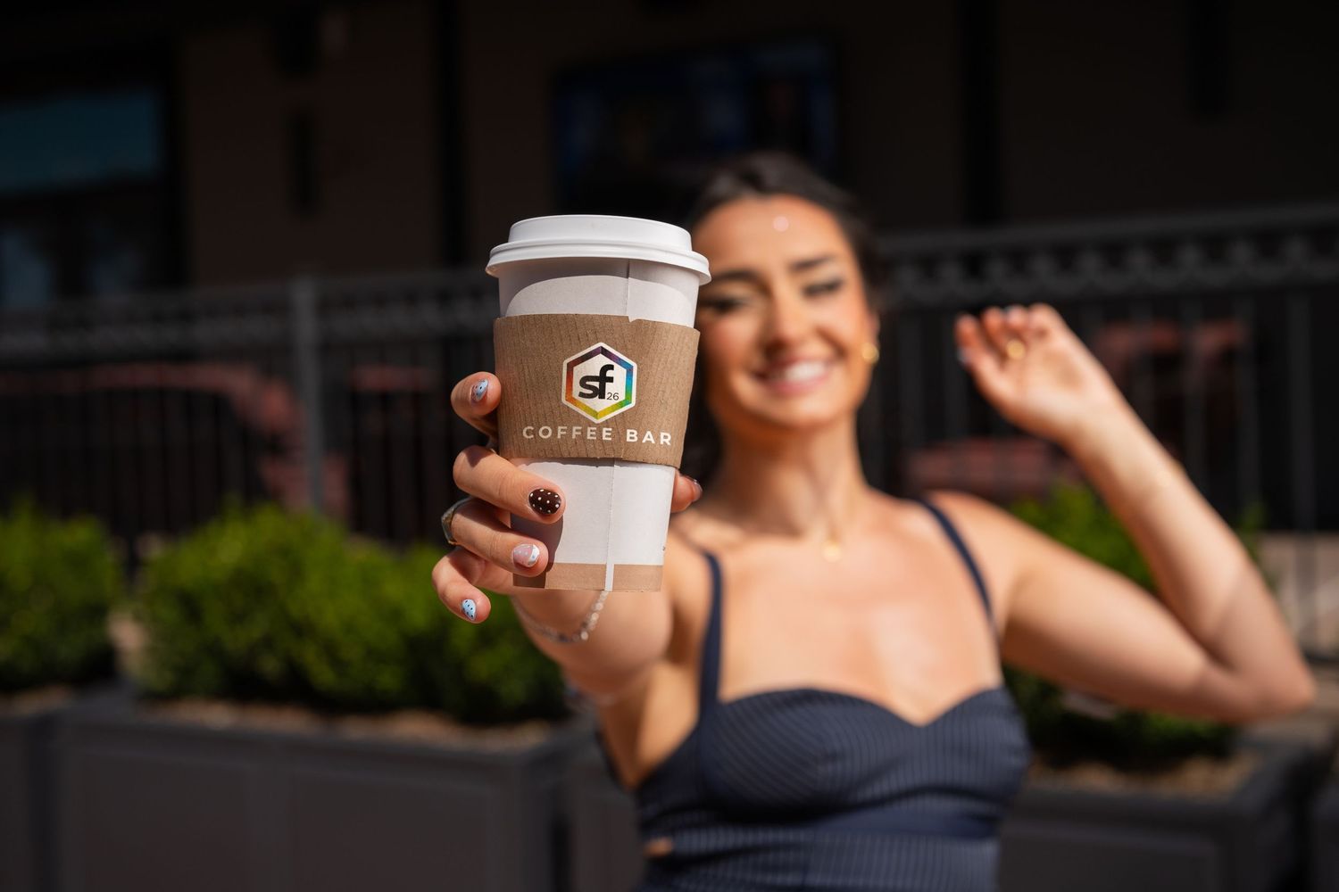 Orlando personal branding photographer Ray Alvarez — lifestyle branding portrait of woman holding branded coffee cup outdoors
