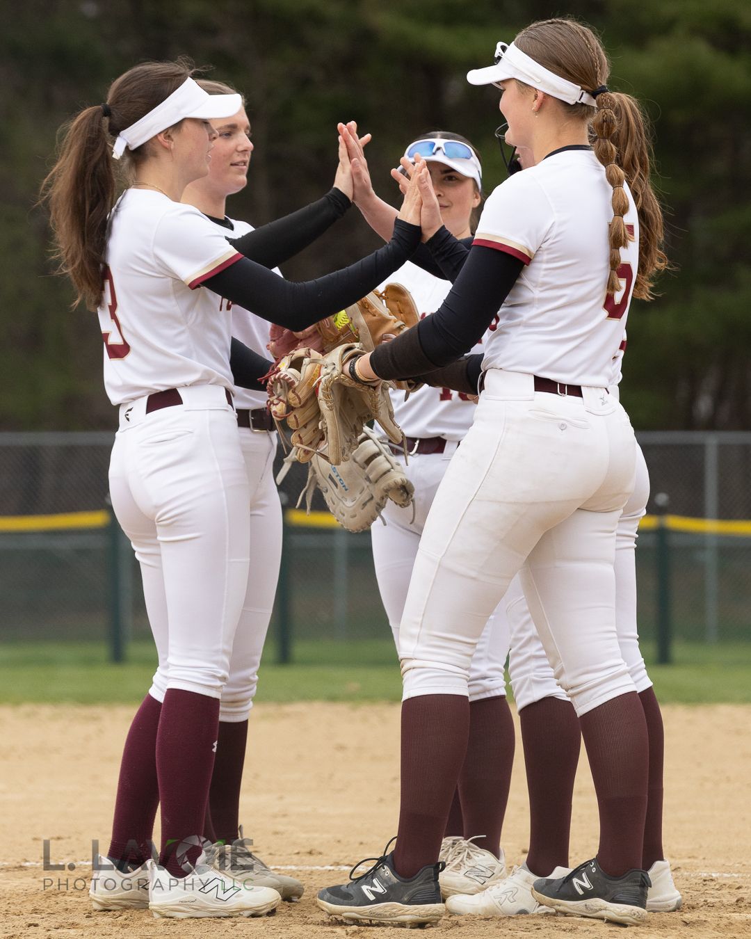 High school softball teammates celebrating together.