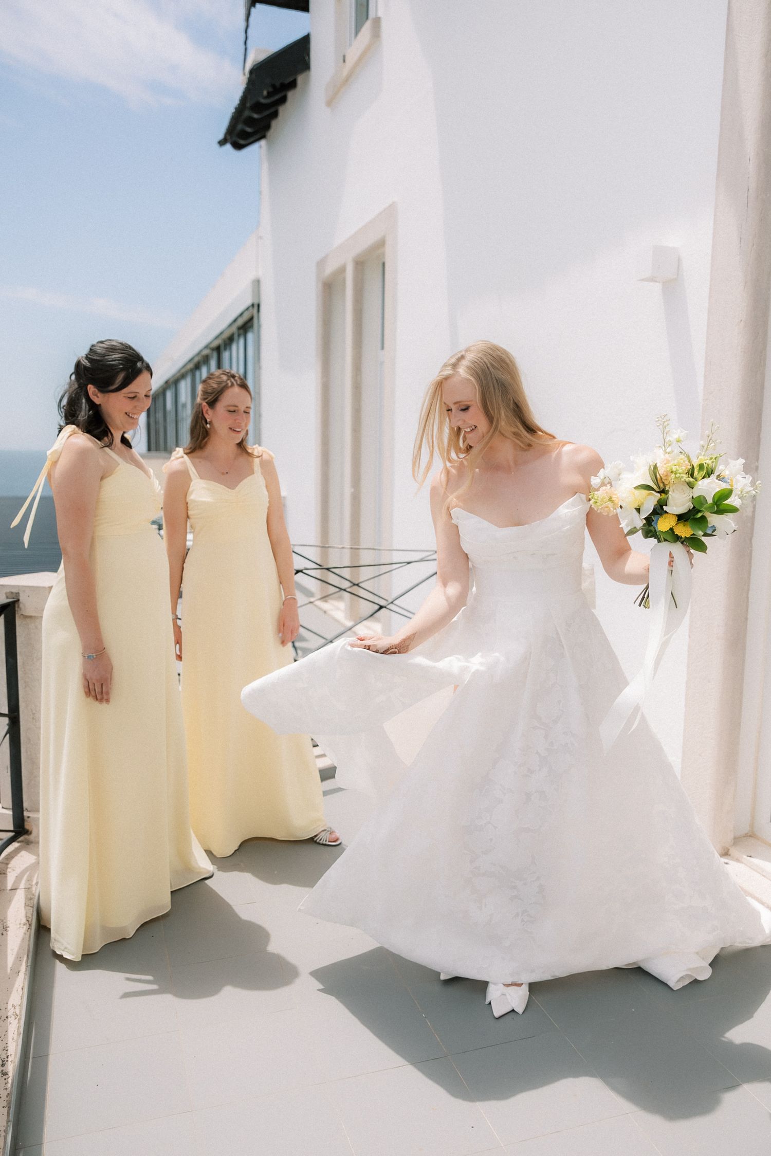 Bridesmaids seeing the bride for the first time during wedding preparations at Farol Hotel before an oceanfront wedding in Portugal.