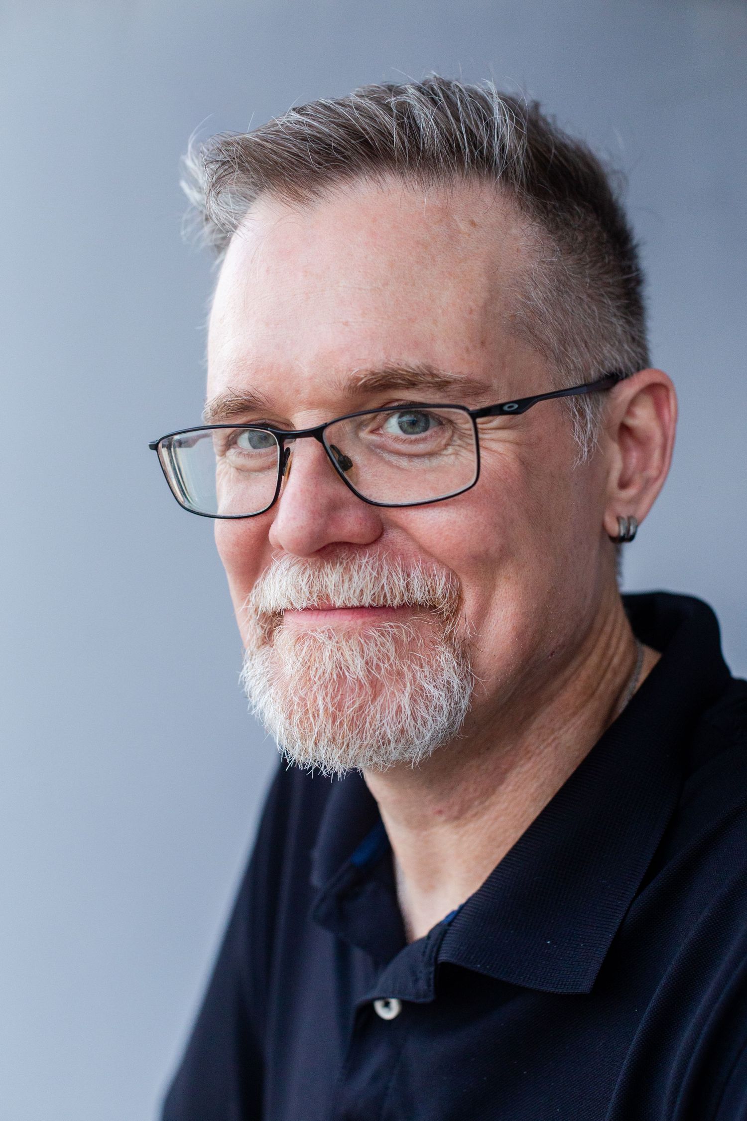 Headshot of a man against a gray background. Guaynabo, Puerto Rico.