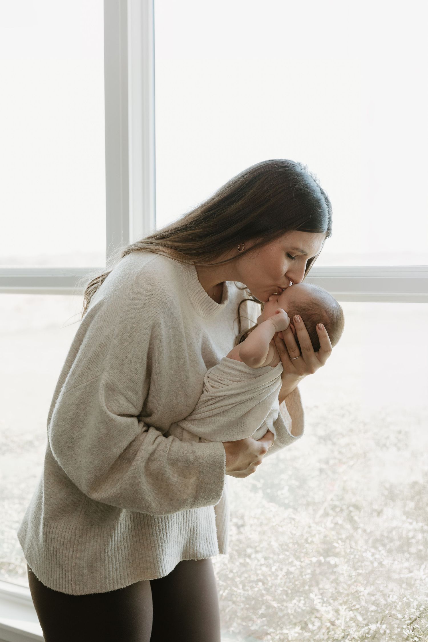 Beautiful natural light mom and baby image taken during an in-home newborn session in Winnsboro Texas