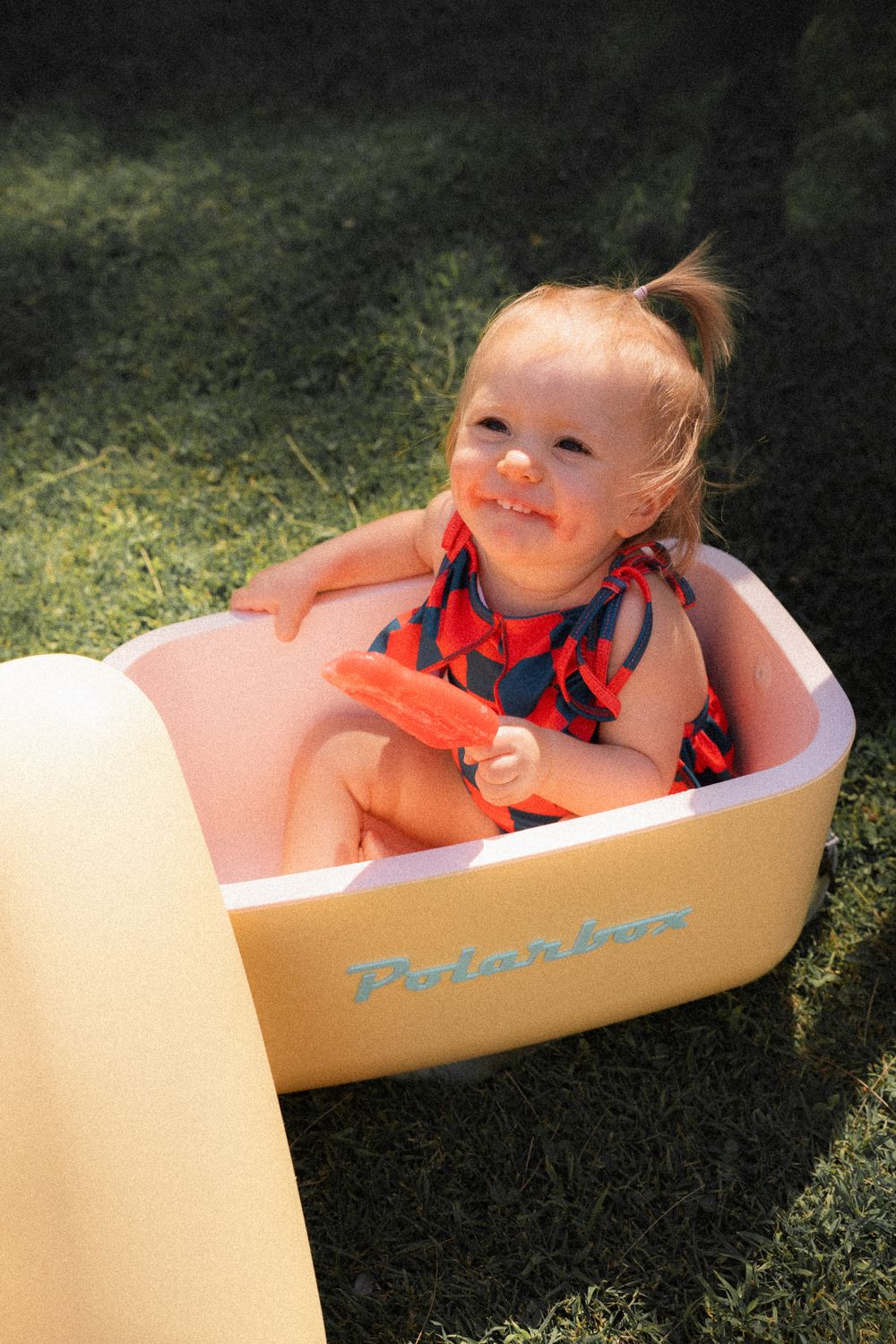 Baby eating ice cream in swimming suit