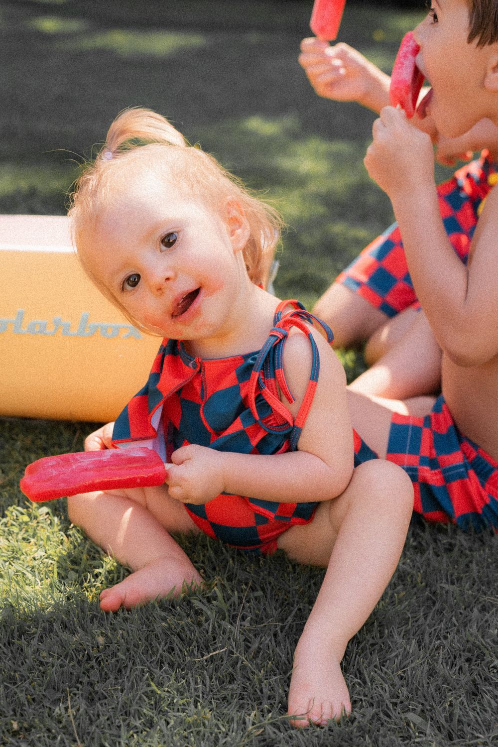 Baby eating ice cream in swimming suit