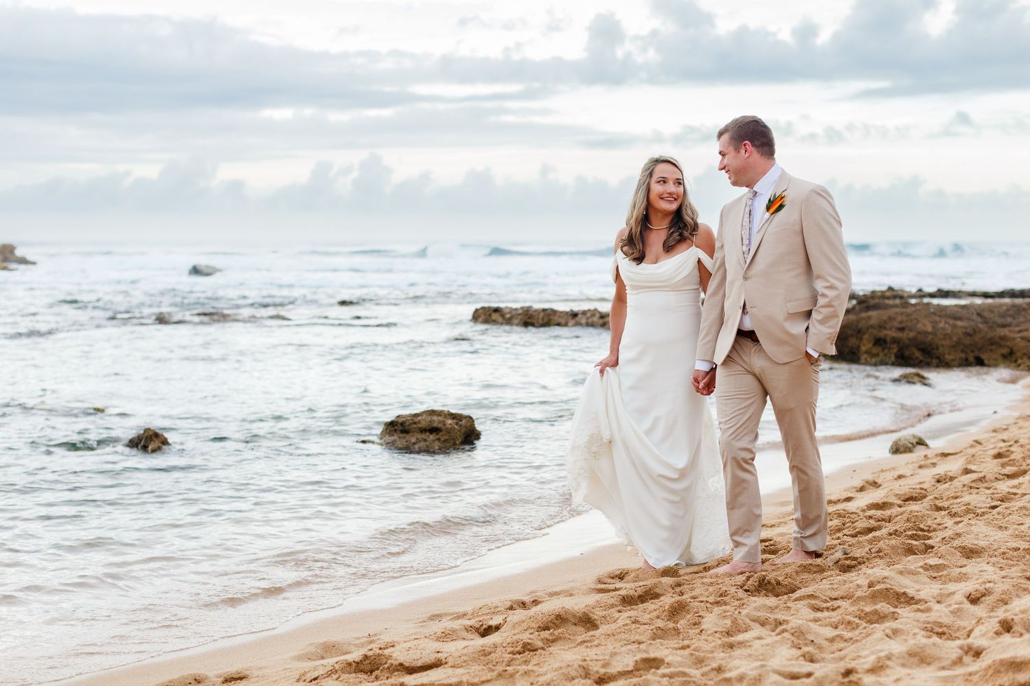 Wedding portrait. Bride and groom walking on the beach. Balneario del Escambrón, Old San Juan, Puerto Rico.