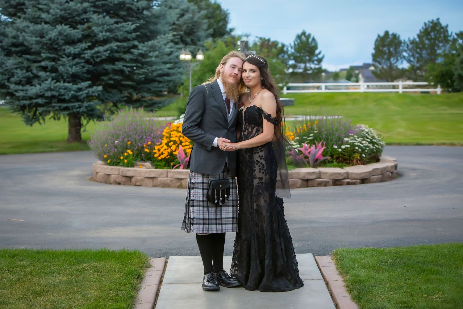 full length portrait of bride wearing black and groom in kilt Castle Gardens Kuna Idaho ©Milestones Studios LLC
