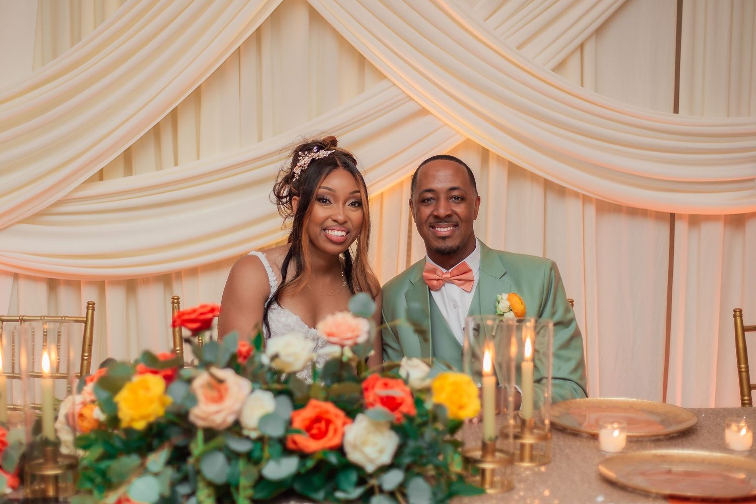 bride and groom sitting at their wedding reception
