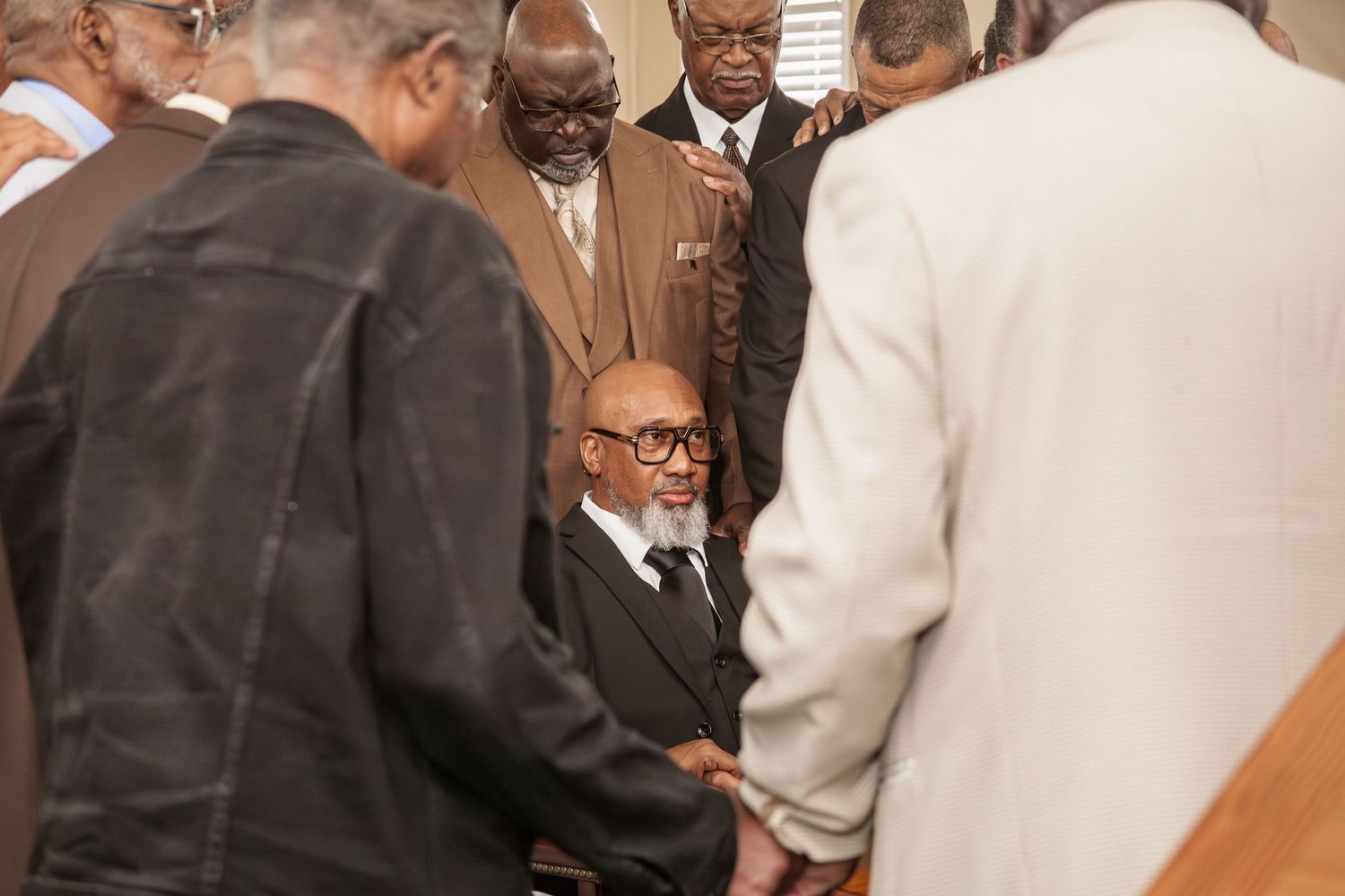 church deacons placing hands on ordained deacon