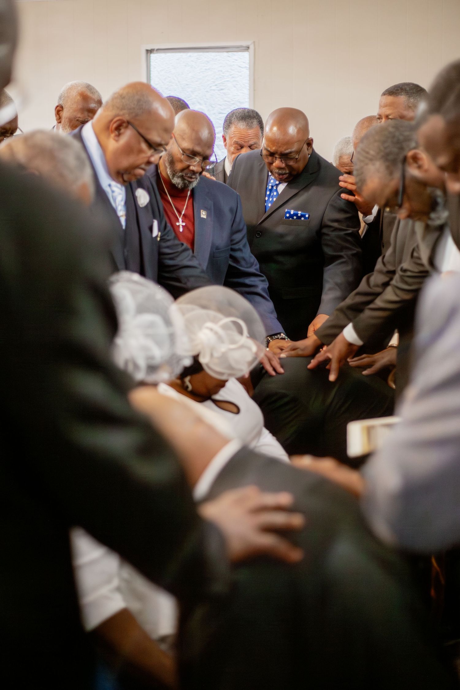 church deacons placing hands on ordained deacon
