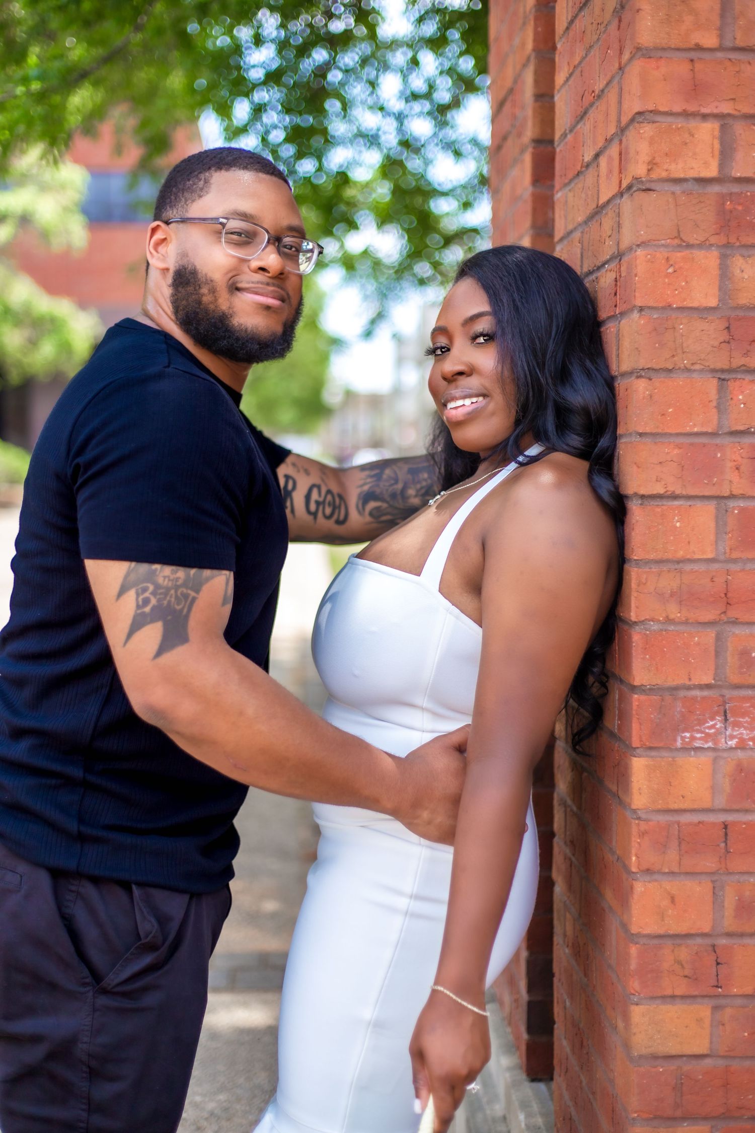 young couple leaning on post outdoor