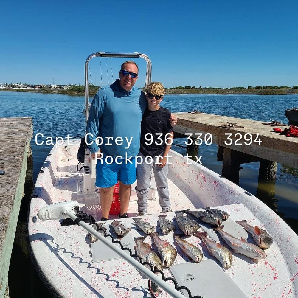 Father and son displaying mixed redfish and trout catch with Capt. Corey in Rockport TX.