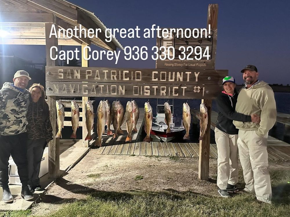 Night fishing group showing redfish catch at San Patricio County Navigation District sign.