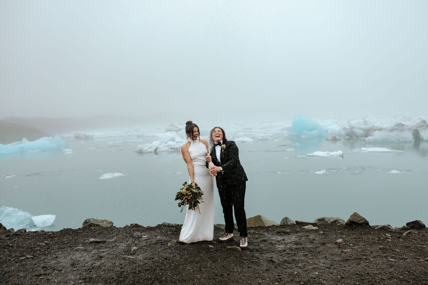 bride popping champagne at Jokulsarlon glacier lagoon in iceland