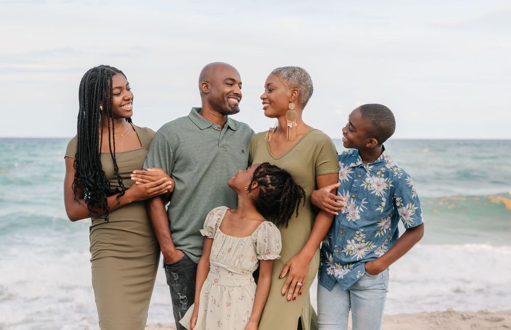 Candid family portrait on the beach in South Florida by Erika Adams Photography