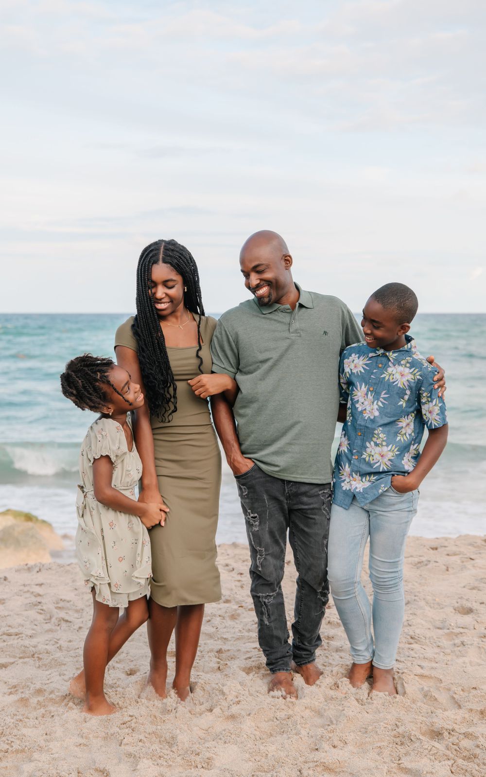 Candid family portrait on the beach in South Florida by Erika Adams Photography
