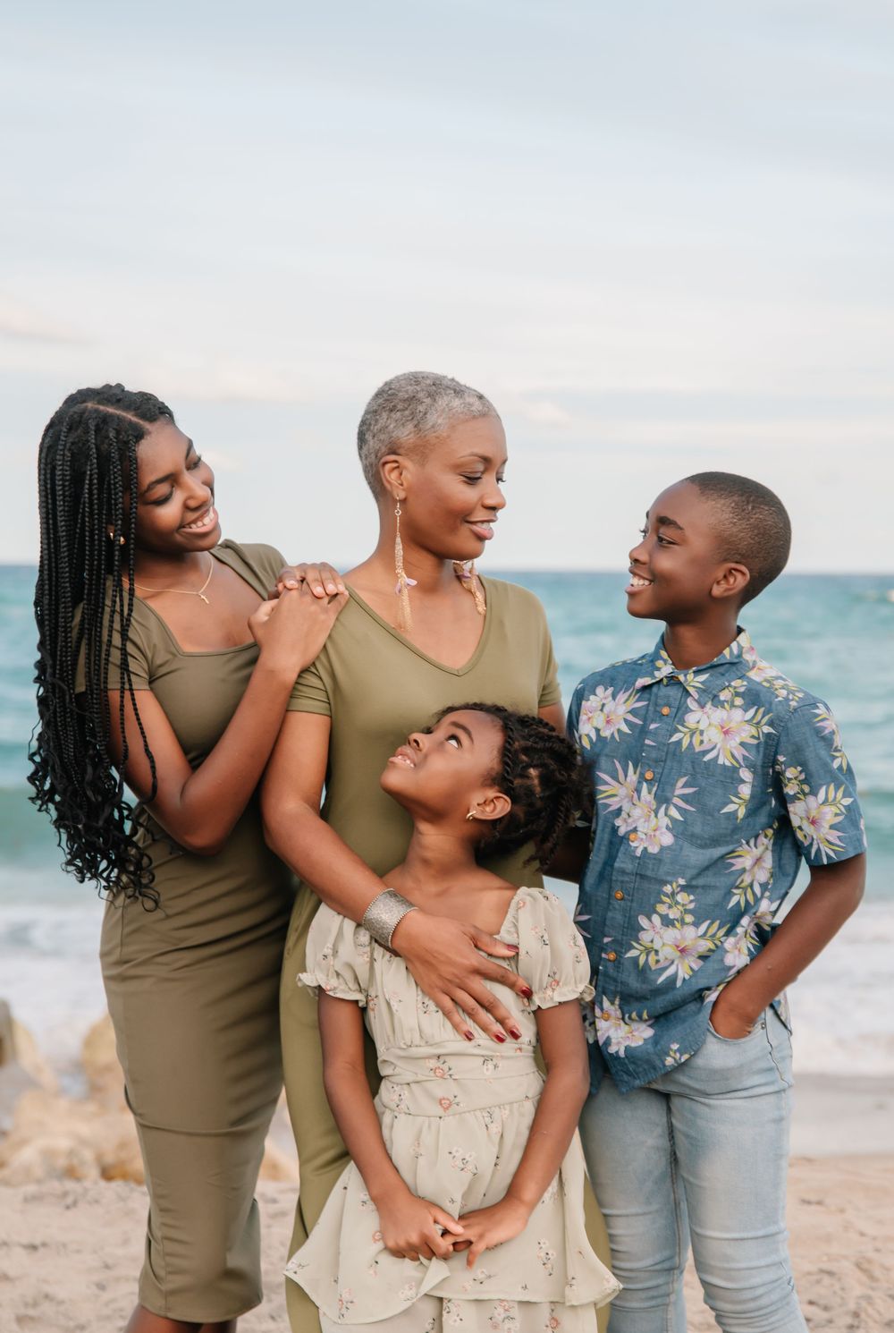 Candid family portrait on the beach in South Florida by Erika Adams Photography