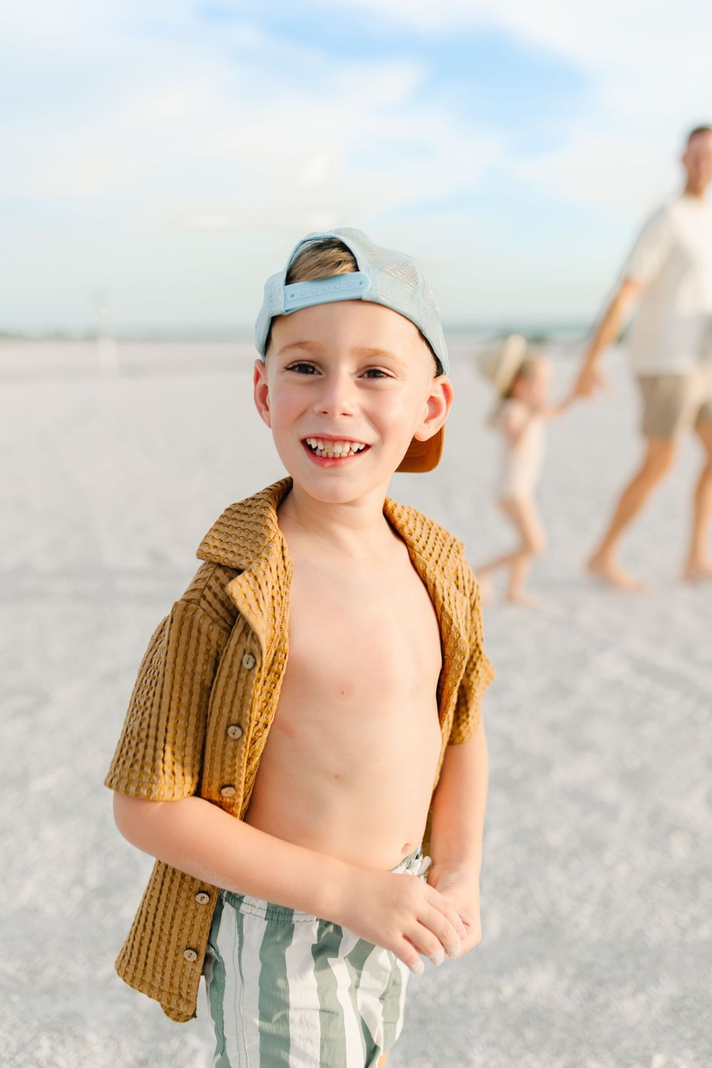 Boy smiling at beach playing during Florida beach photoshoot