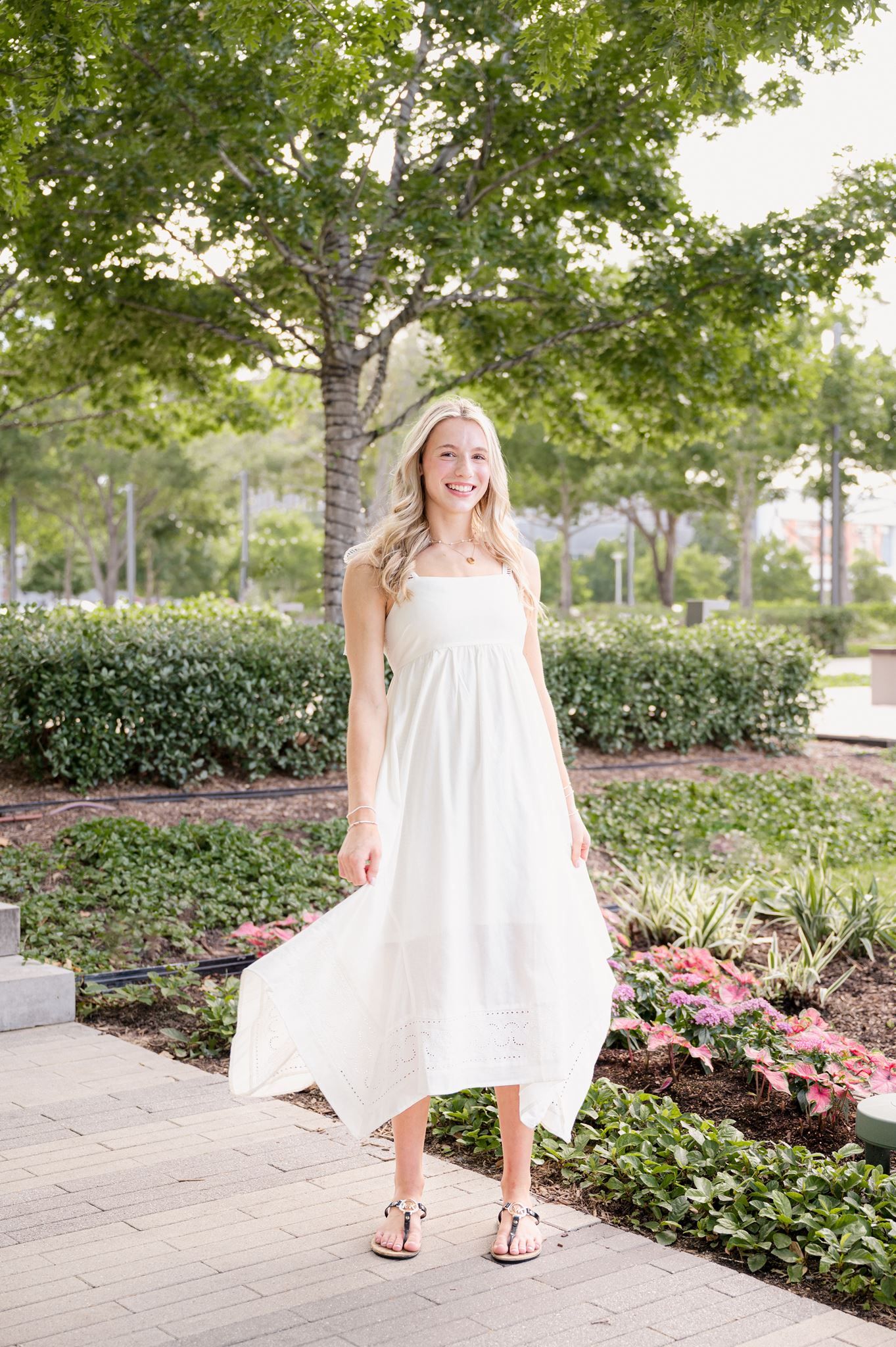 High school senior girl wearing a flowy white dress.