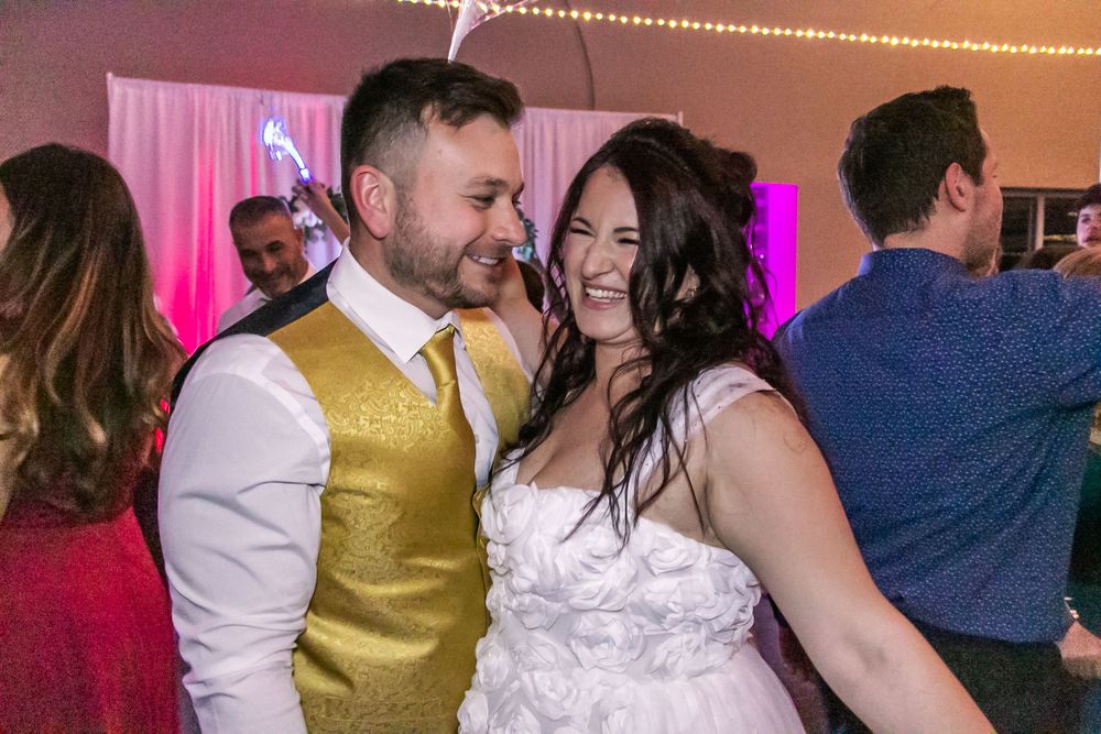 Channel Side Club in Palm Coast Florida. Wedding photography of fun wedding reception. People dancing at party.