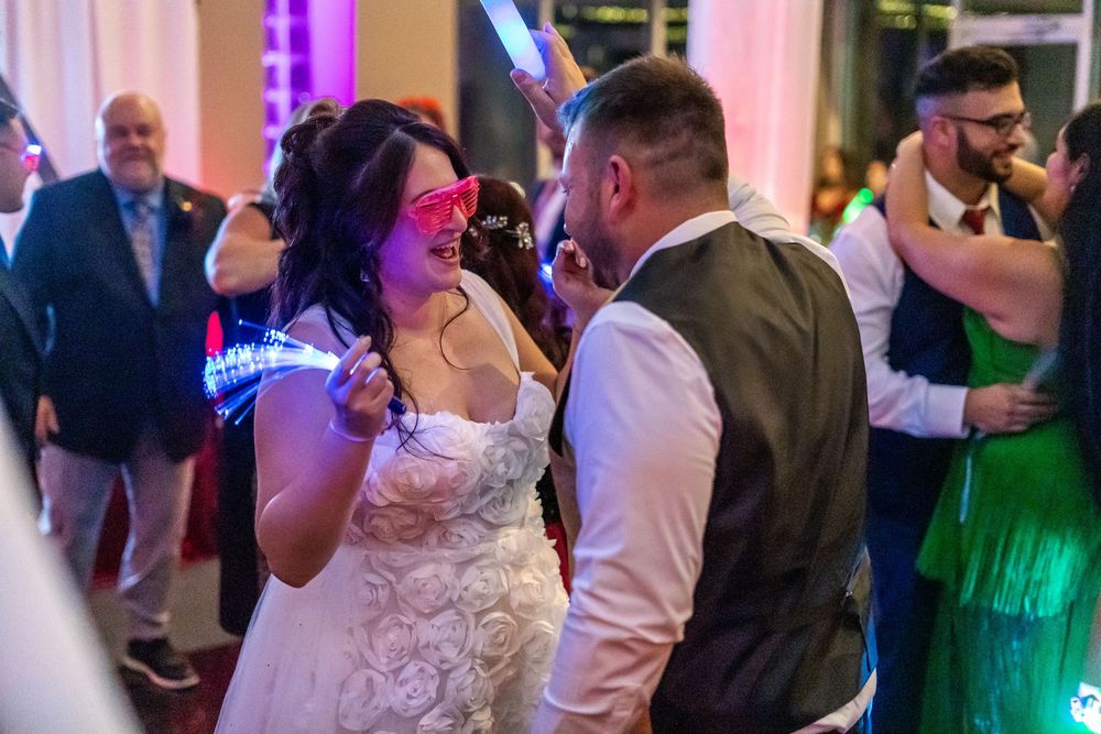 Channel Side Club in Palm Coast Florida. Wedding photography of fun wedding reception. People dancing at party.