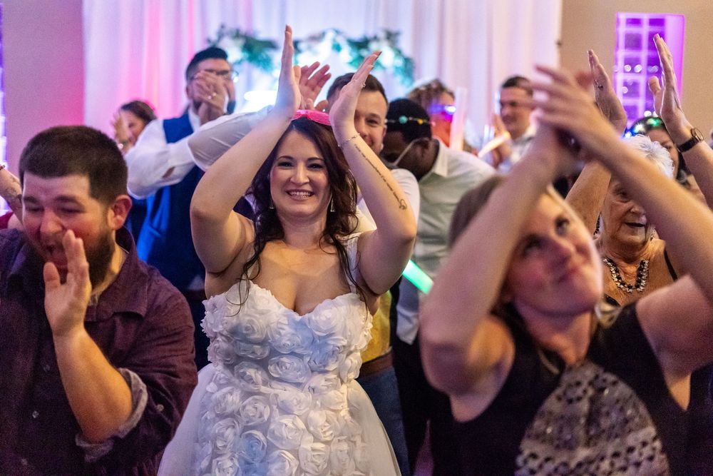 Channel Side Club in Palm Coast Florida. Wedding photography of fun wedding reception. People dancing at party.