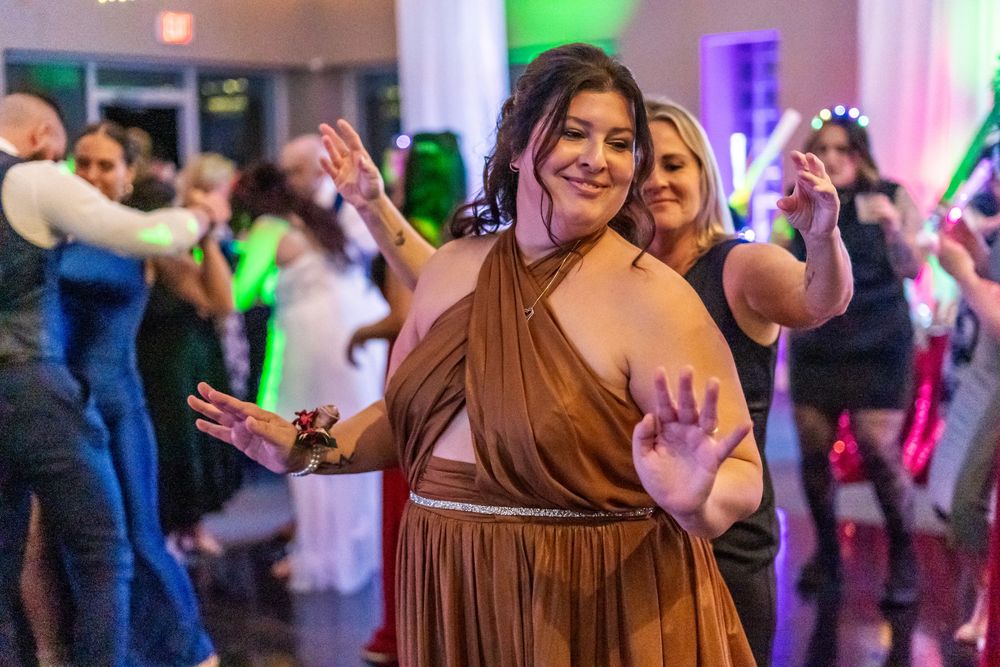 Channel Side Club in Palm Coast Florida. Wedding photography of fun wedding reception. People dancing at party.