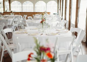 Details of wedding reception that include, linen, serving utensils, butter yellow napkins, and wild flower decor in Sherwood, MI