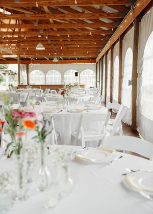 Details of wedding reception that include, linen, serving utensils, butter yellow napkins, and wild flower decor in Sherwood, MI