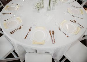 Details of wedding reception that include, linen, serving utensils, butter yellow napkins, and wild flower decor in Sherwood, MI