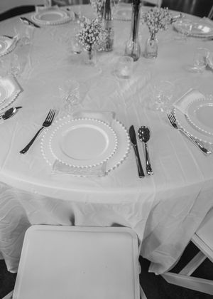 Details of wedding reception that include, linen, serving utensils, butter yellow napkins, and wild flower decor in Sherwood, MI