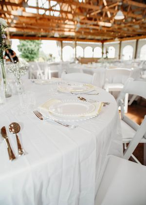 Details of wedding reception that include, linen, serving utensils, butter yellow napkins, and wild flower decor in Sherwood, MI