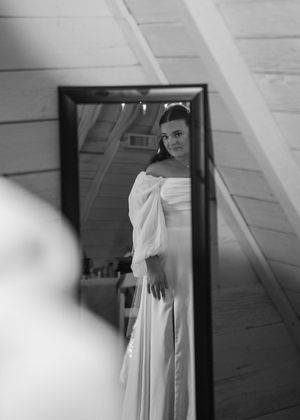 Bride looking in mirror during getting ready in Sherwood,MI