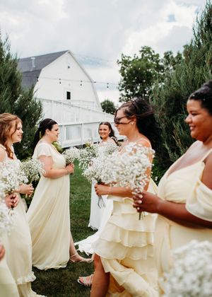Bridal portraits of bride and bridesmaids walking in front of bride for unique photo in Sherwood,MI