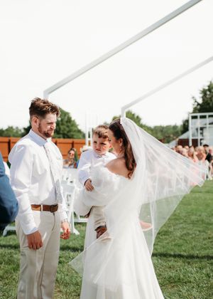 Bride, Groom and child during ceremony in Sherwood,MI