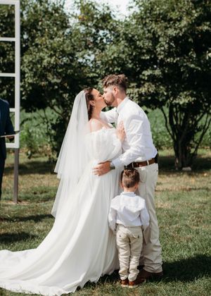 Bride and Groom kissing during ceremony in Sherwood,MI