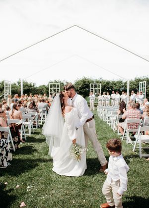 Bride and Groom doing a dip kiss in aisle during ceremony in Sherwood, MI