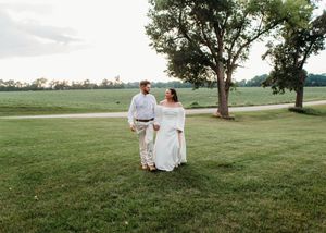 Bride and Groom walking hand in hand during wedding portraits in Sherwood,MI..