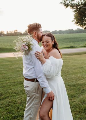 Bride laughing during portraits of bride and groom in Sherwood,MI