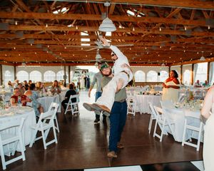 Best man carrying groom to the dance floor in Sherwood,MI