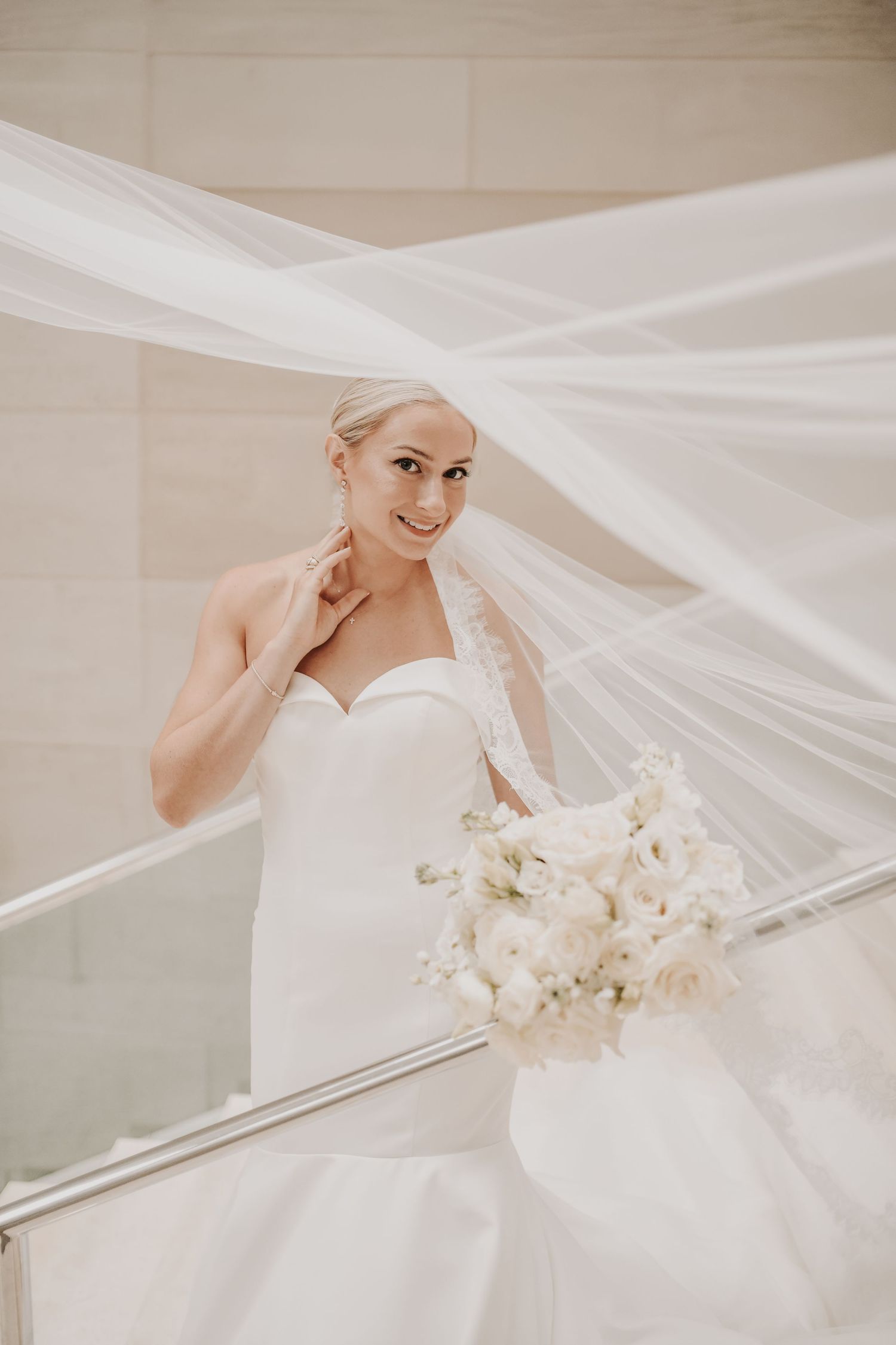 Dramatic flying veil bridal portrait on the Meyerson Symphony Center staircase
