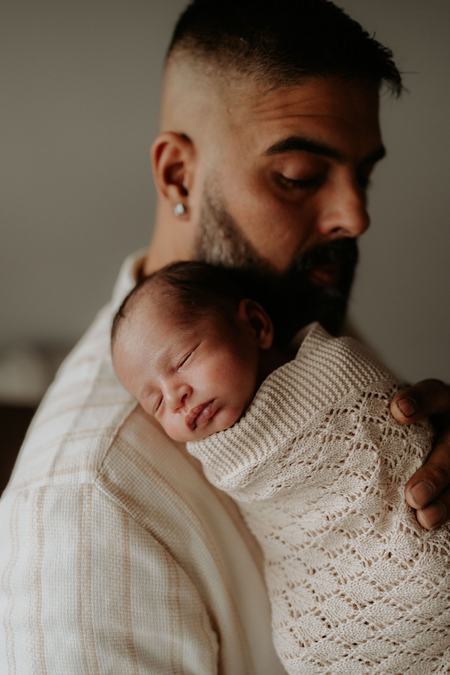 Dad cuddling newborn during in home newborn session in Picton NSW