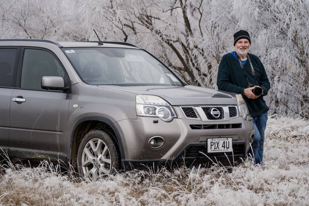 stewart nimmo standing next to his vehicle in the hoar frost with his sony camera