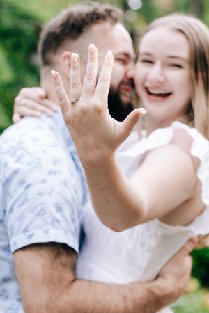 woman showing her engagement ring with a smile