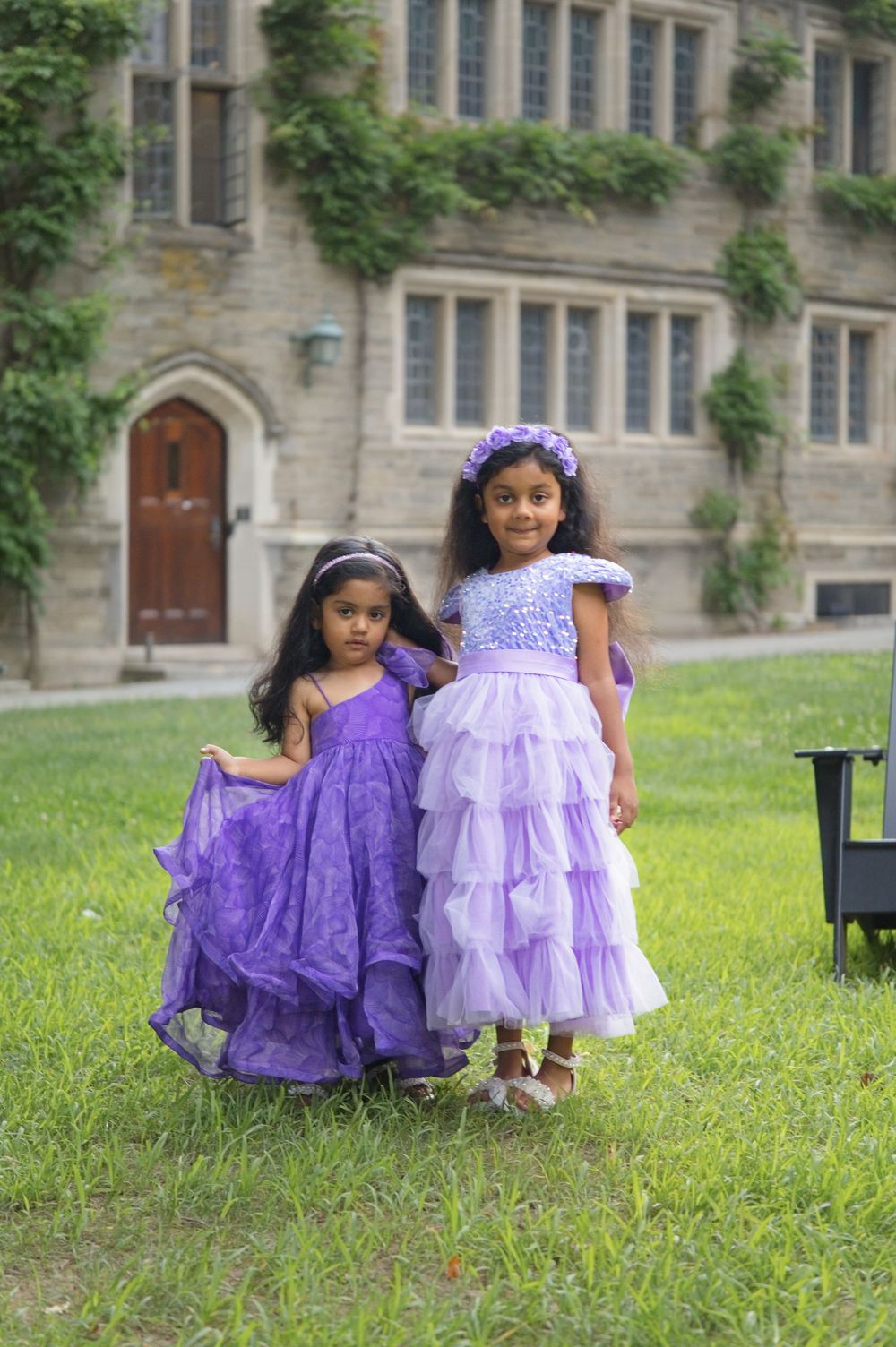 Two sisters in matching purple tulle dresses on the lawn at Princeton University, NJ family photos