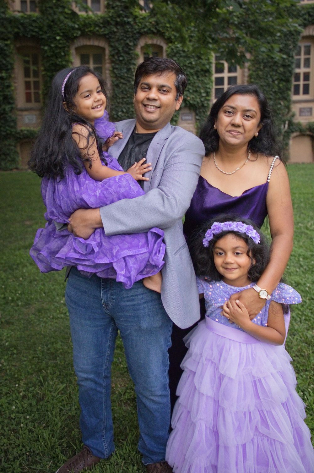 Family of four in coordinated purple outfits on the Princeton University campus, Central NJ family photographer