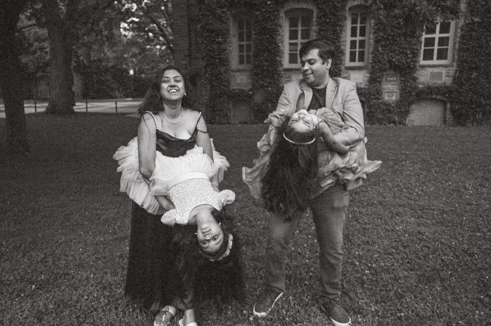 Black and white candid of a family laughing together outdoors, natural New Jersey family photography