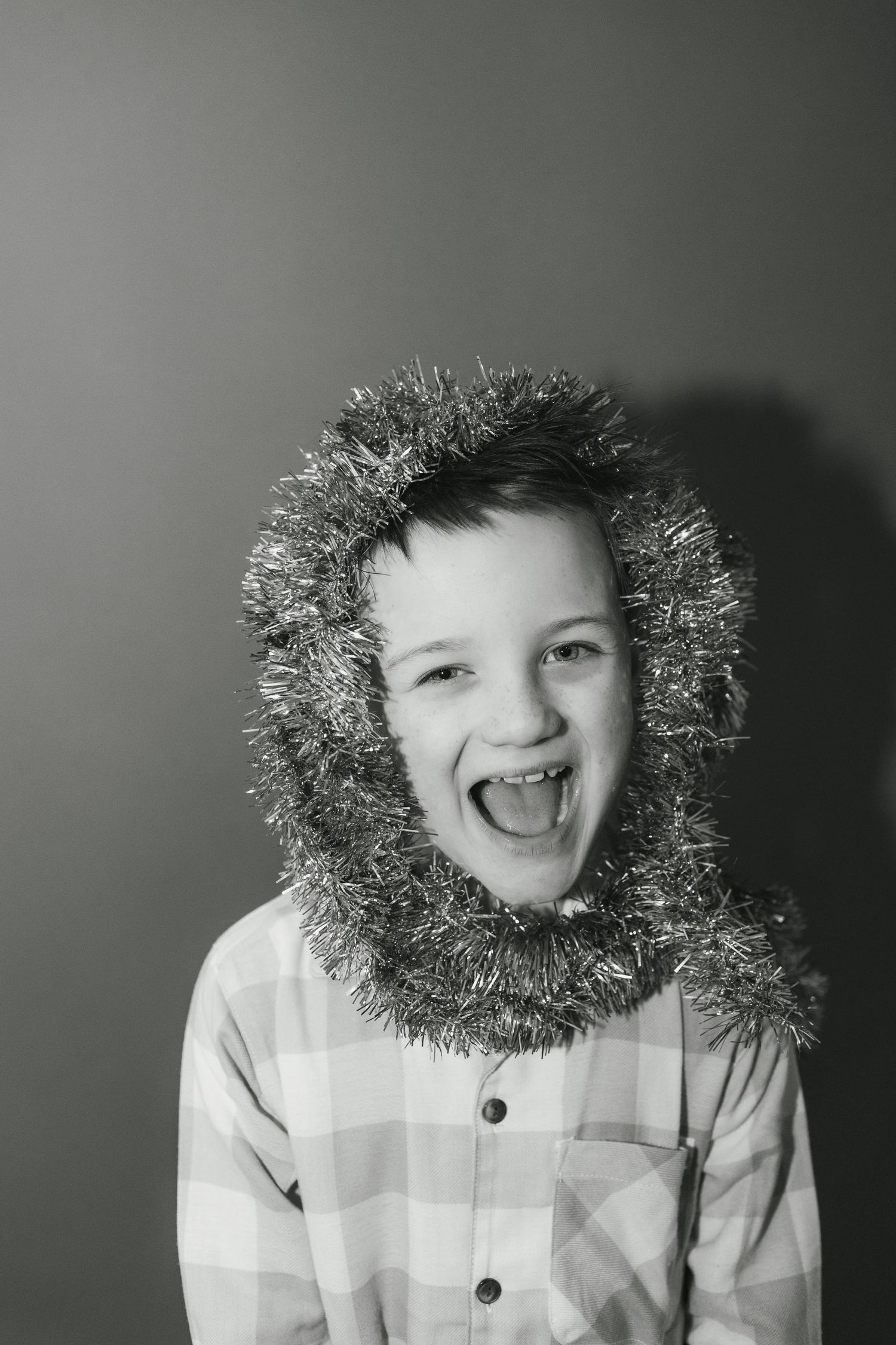 A black and white image showing a disco ball being held up while a small child watches in wonder.