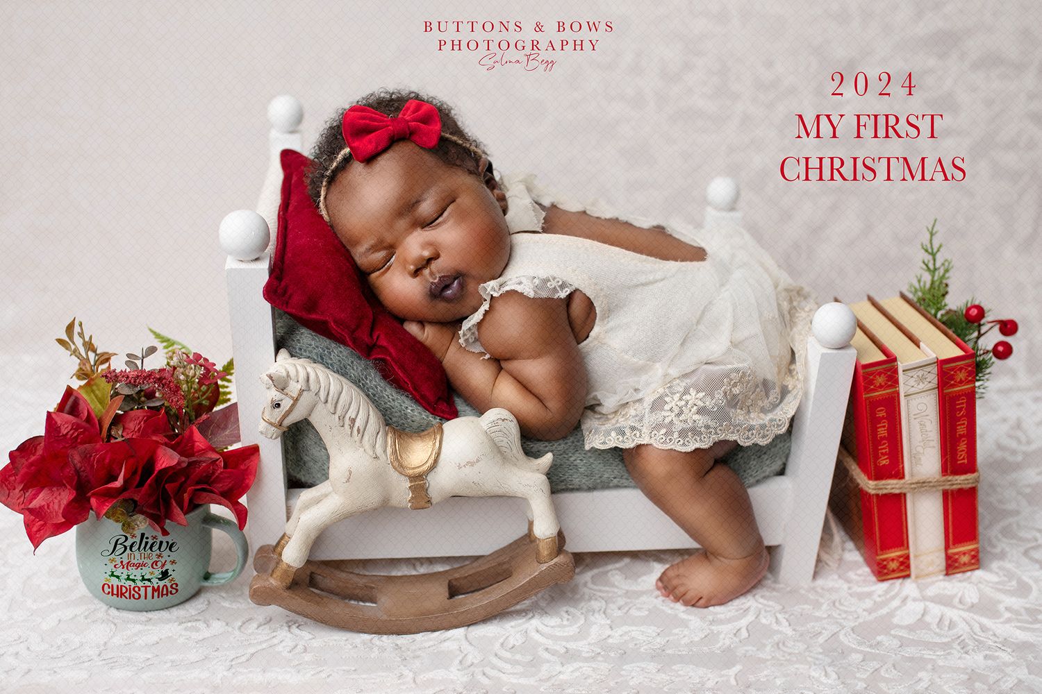 Baby’s first Christmas portraits Ipswich and Brisbane – African baby sleeping on rocking horse surrounded by gifts, Springfield Lakes studio