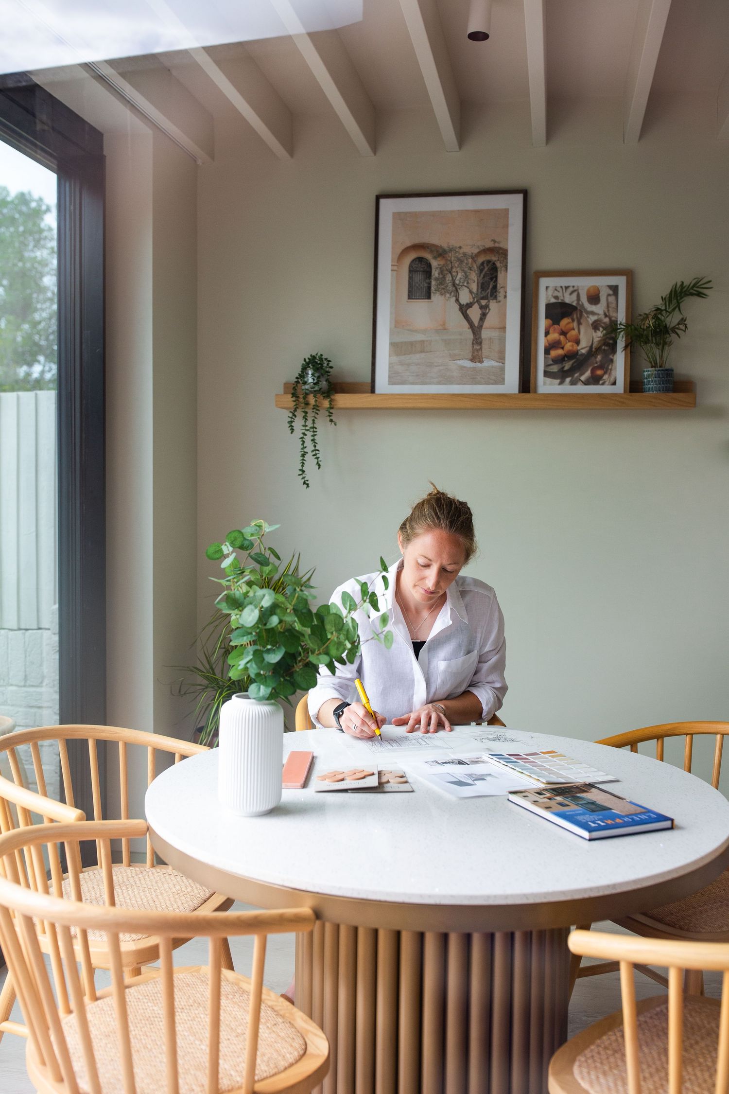 Business branding photography in Surrey showing a creative professional working at her table in her studio