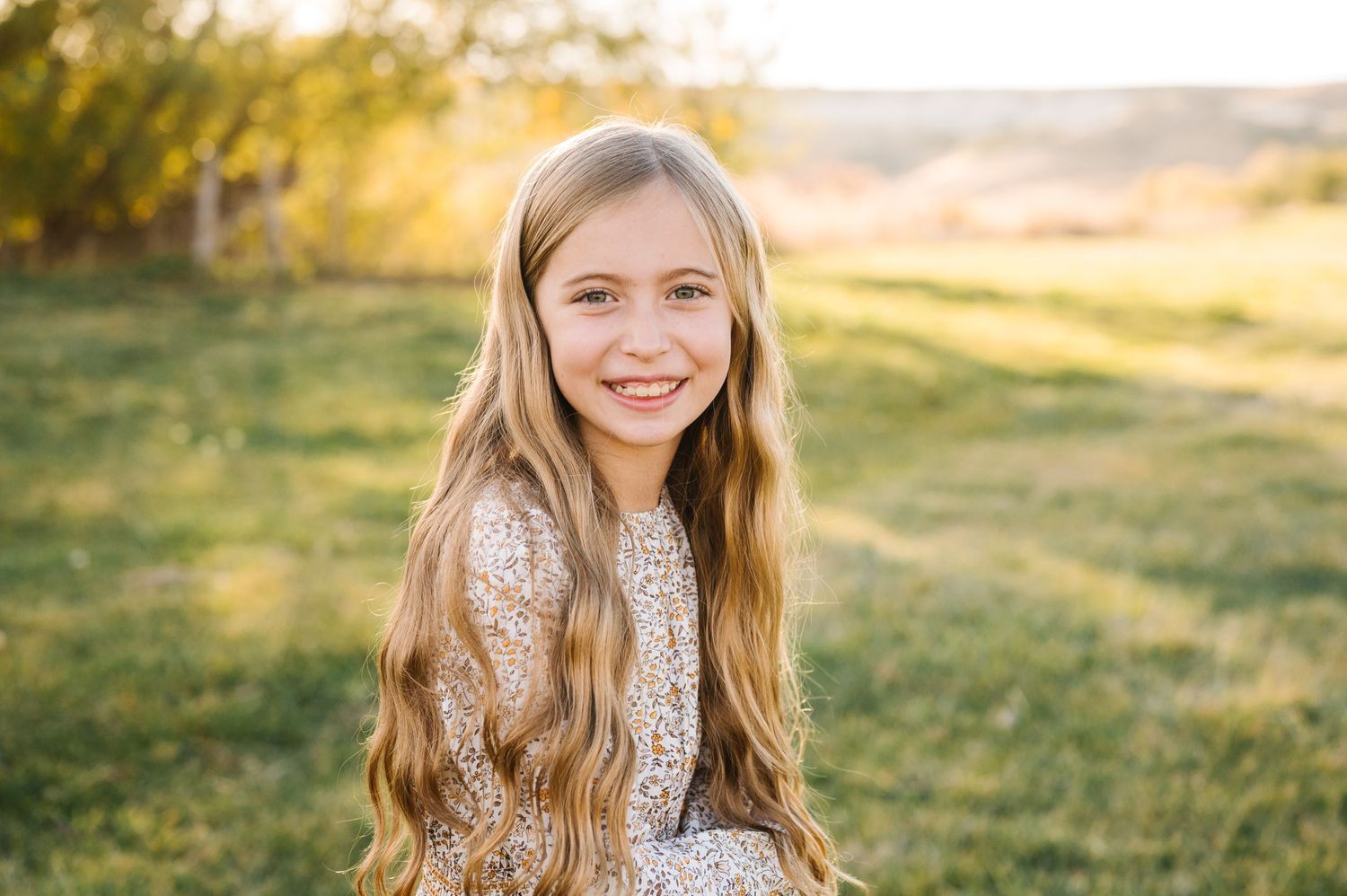 Portrait of someone in lace dress outdoors during golden hour.